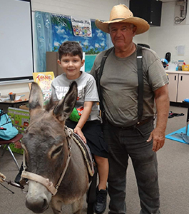 student on a donkey in the classroom