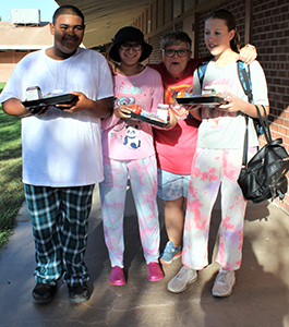 Four happy students wearing pajamas